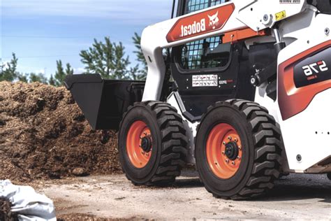 climbing a curb wheel or track skid steer|wheeled skid steer.